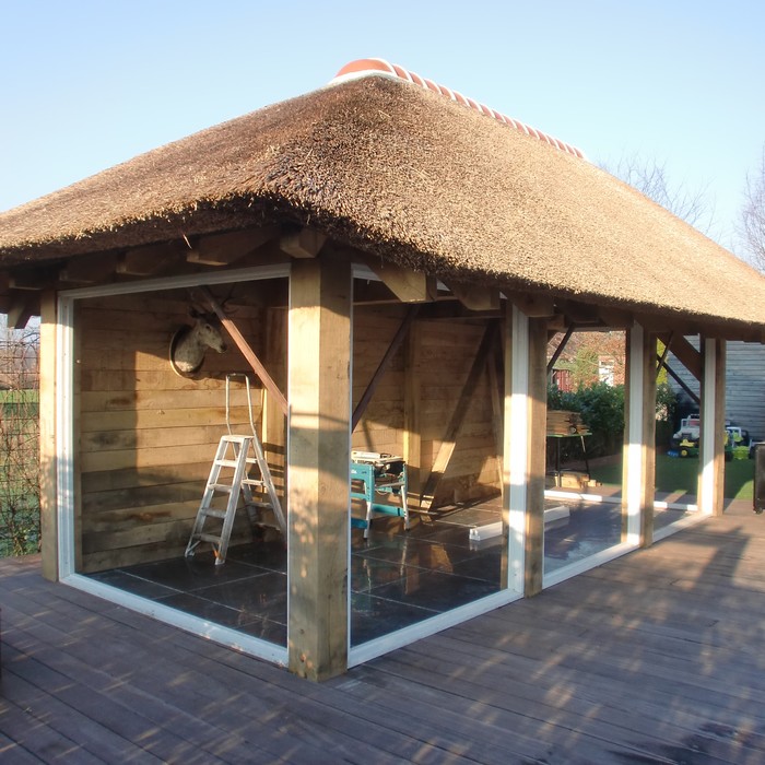 Exclusive bespoke oak framed gazebo with heavy beams and a thatched roof