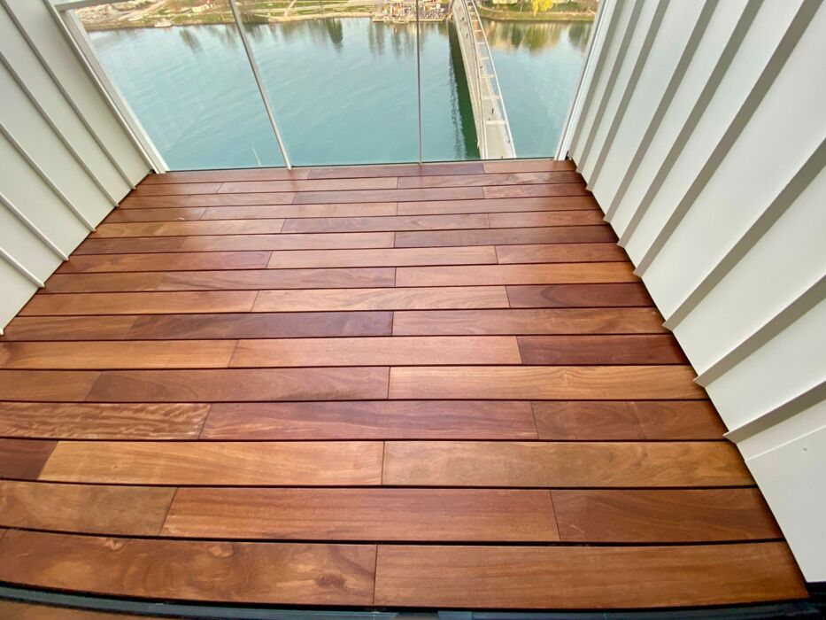 Freshly oiled Ipé hardwood decking on an apartment balcony overlooking the Rhine – installed with hidden clips