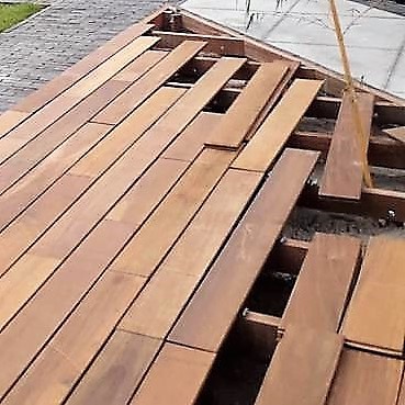 Close-up of Ipé decking boards clicking into a hidden clip profile