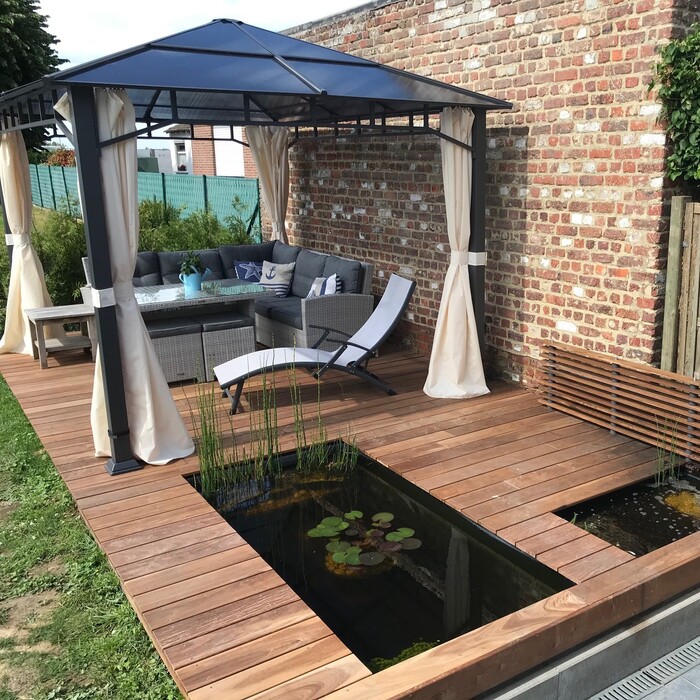 Luxury Ipe hardwood decking adjacent to a contemporary pond
