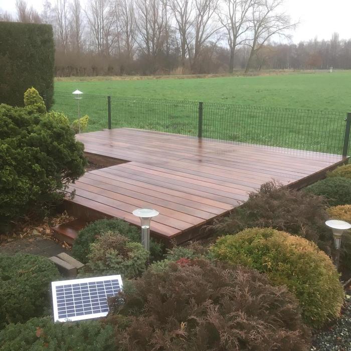 Durable Mukulungu hardwood decking with a warm reddish-brown color
